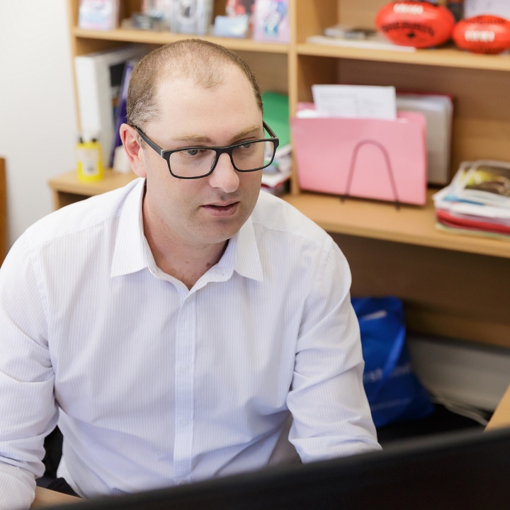 Matt La Rocca working at his desk on a client file at Mortgage Choice Hoppers Crossing